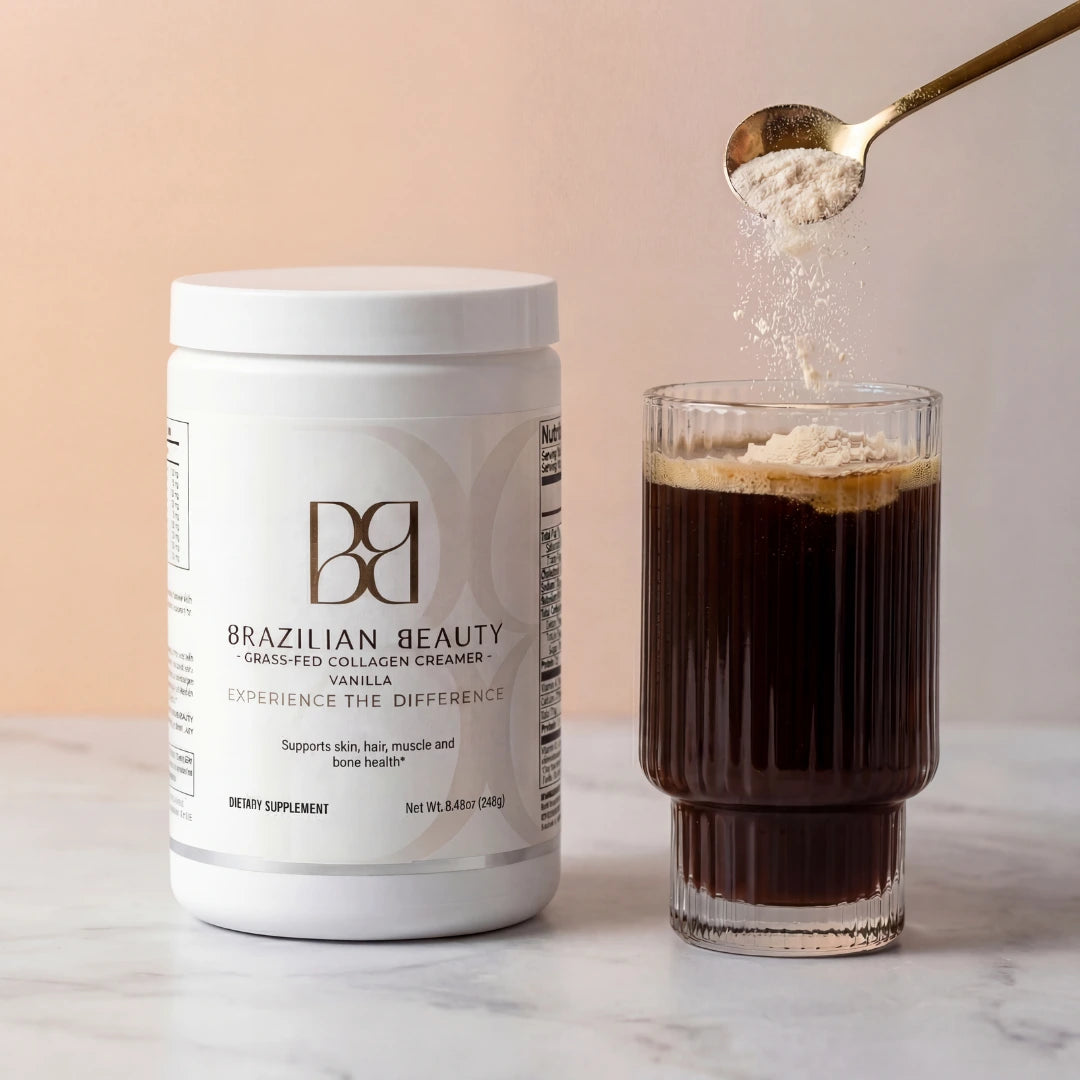 Container of Brazilian Beauty collagen creamer with a glass of coffee and a spoonful of powder on a marble surface.